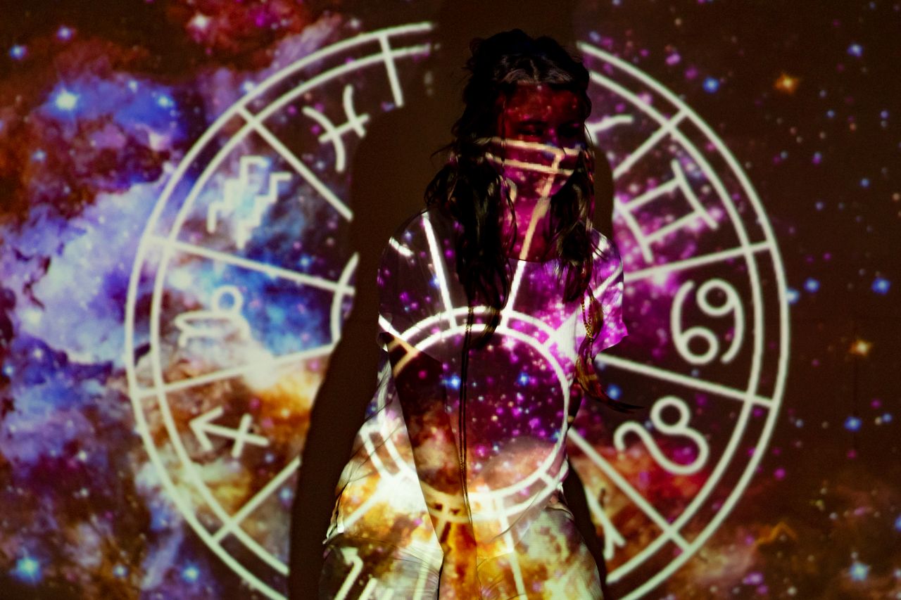 The Art of Drawing Readers In: Your attractive post title goes here A mystical image of a woman enveloped in celestial projections and astrological symbols.