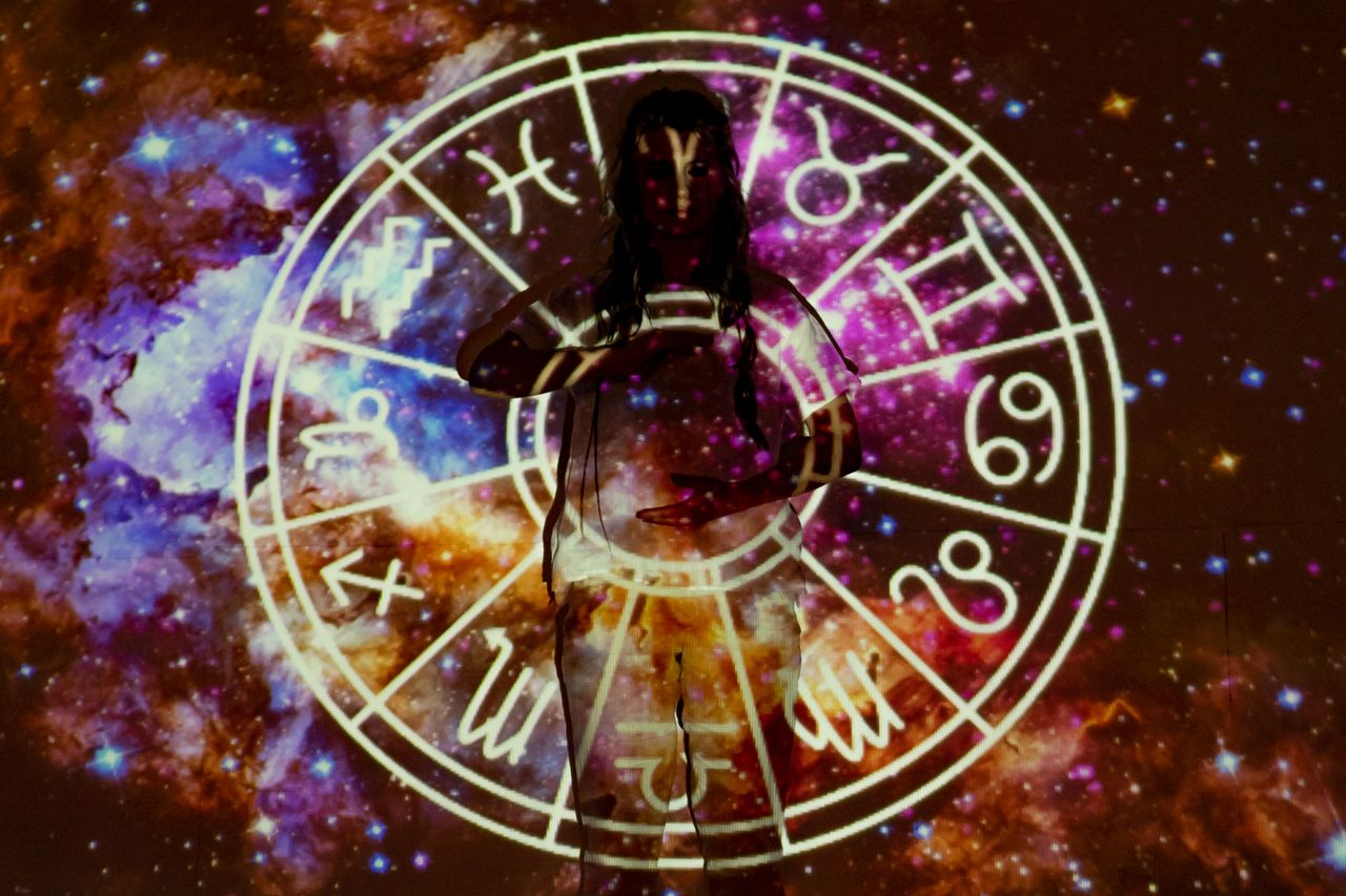 Mastering the First Impression: Your intriguing post title goes here Woman standing with astrological symbols projected, evoking a mystical vibe.